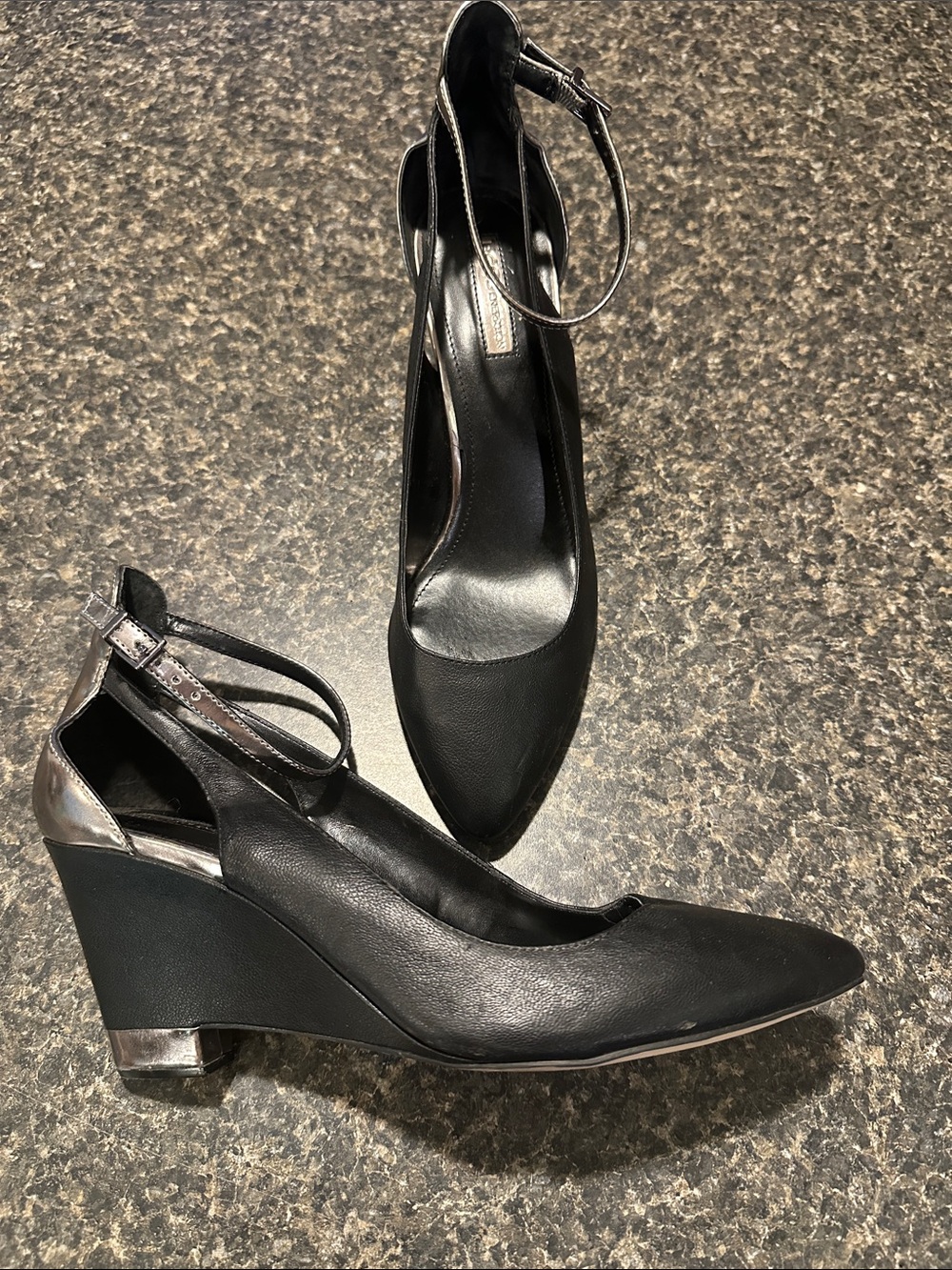 BCBGeneration Black Pointed Wedge Pumps with Ankle Strap and Metallic Accent